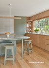 Kitchen with timber features, and painted in Resene Double Lemon Grass and Resene Quarter Thorndon Cream