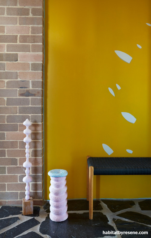 yellow feature wall, yellow interior, brick interior, flooring ideas, gold feature wall